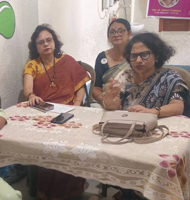 Women seated together at a community gathering shared by the society