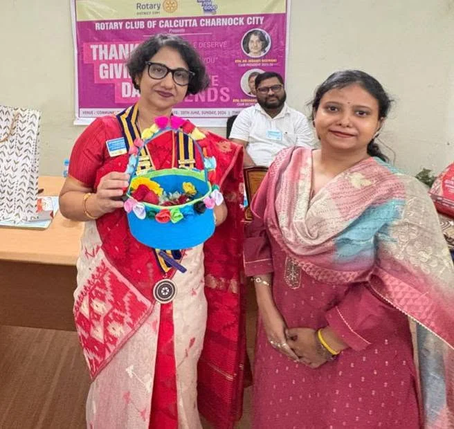 Participants posing with a colourful handmade item at a community occasion