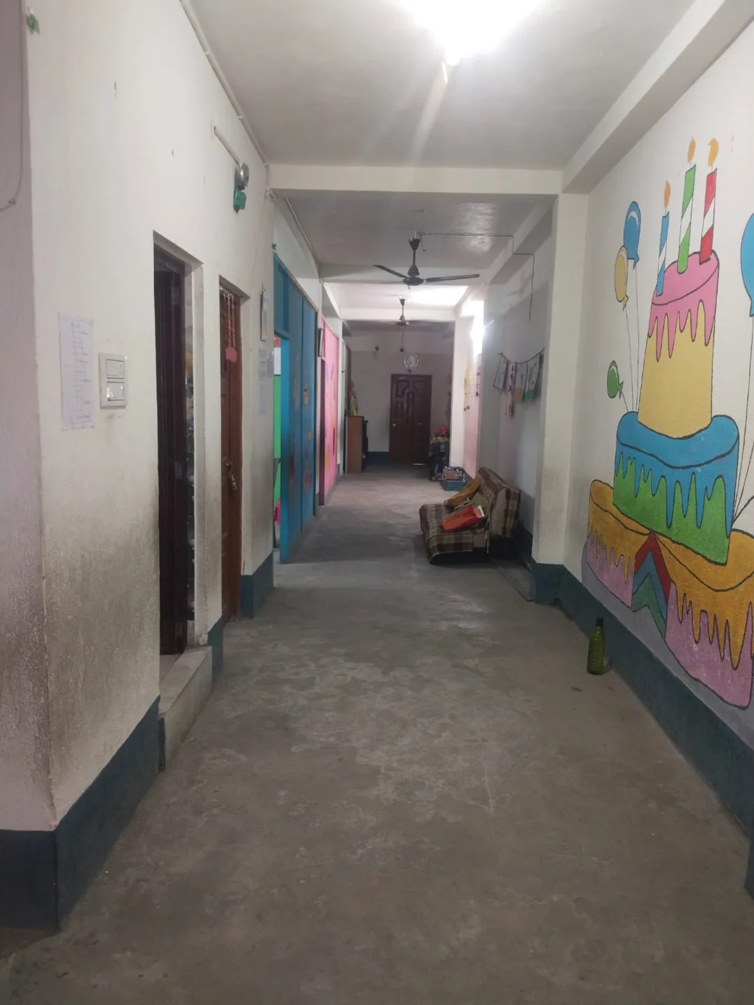 A corridor with colourful wall art