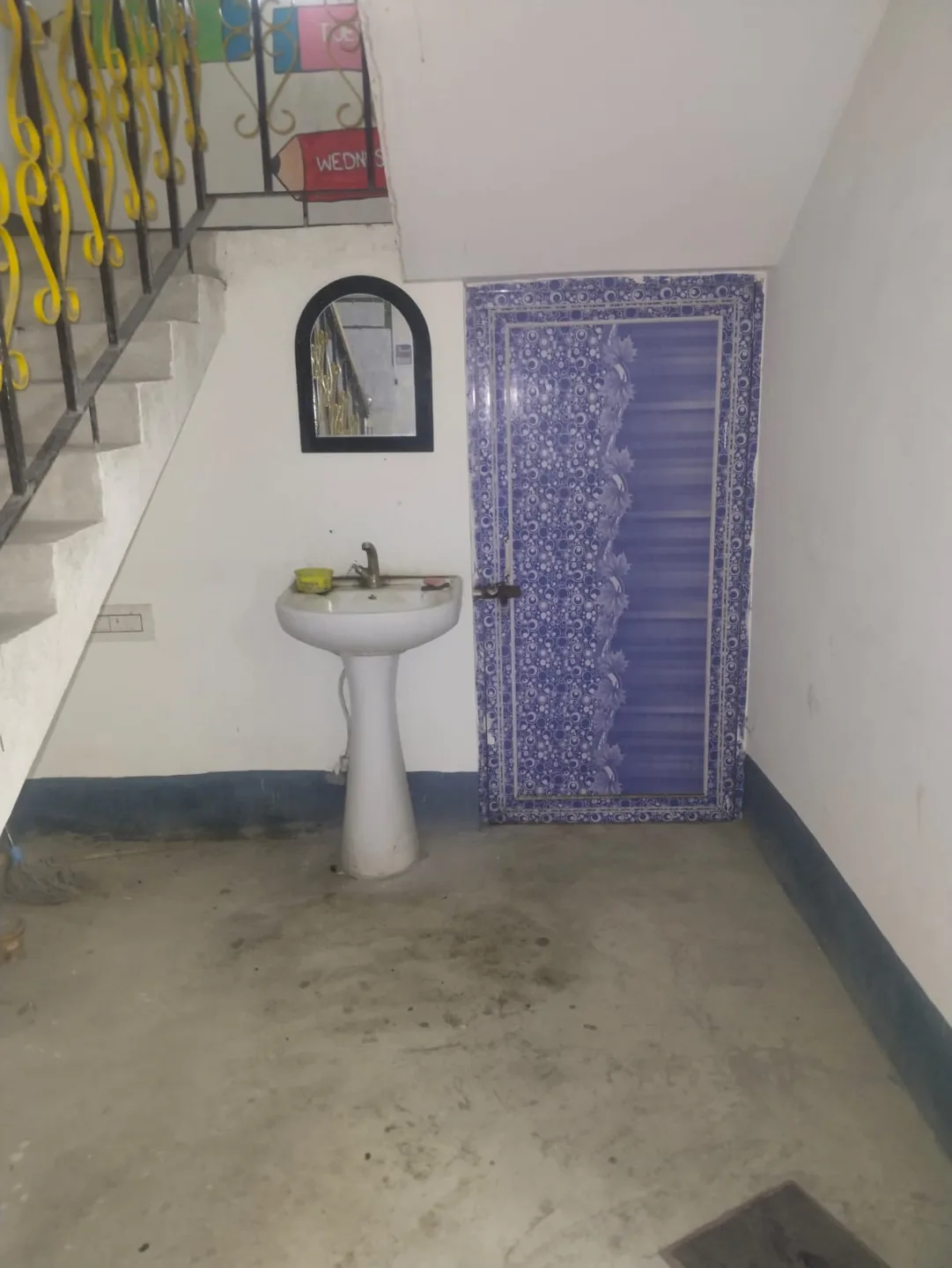 A washbasin beneath the staircase