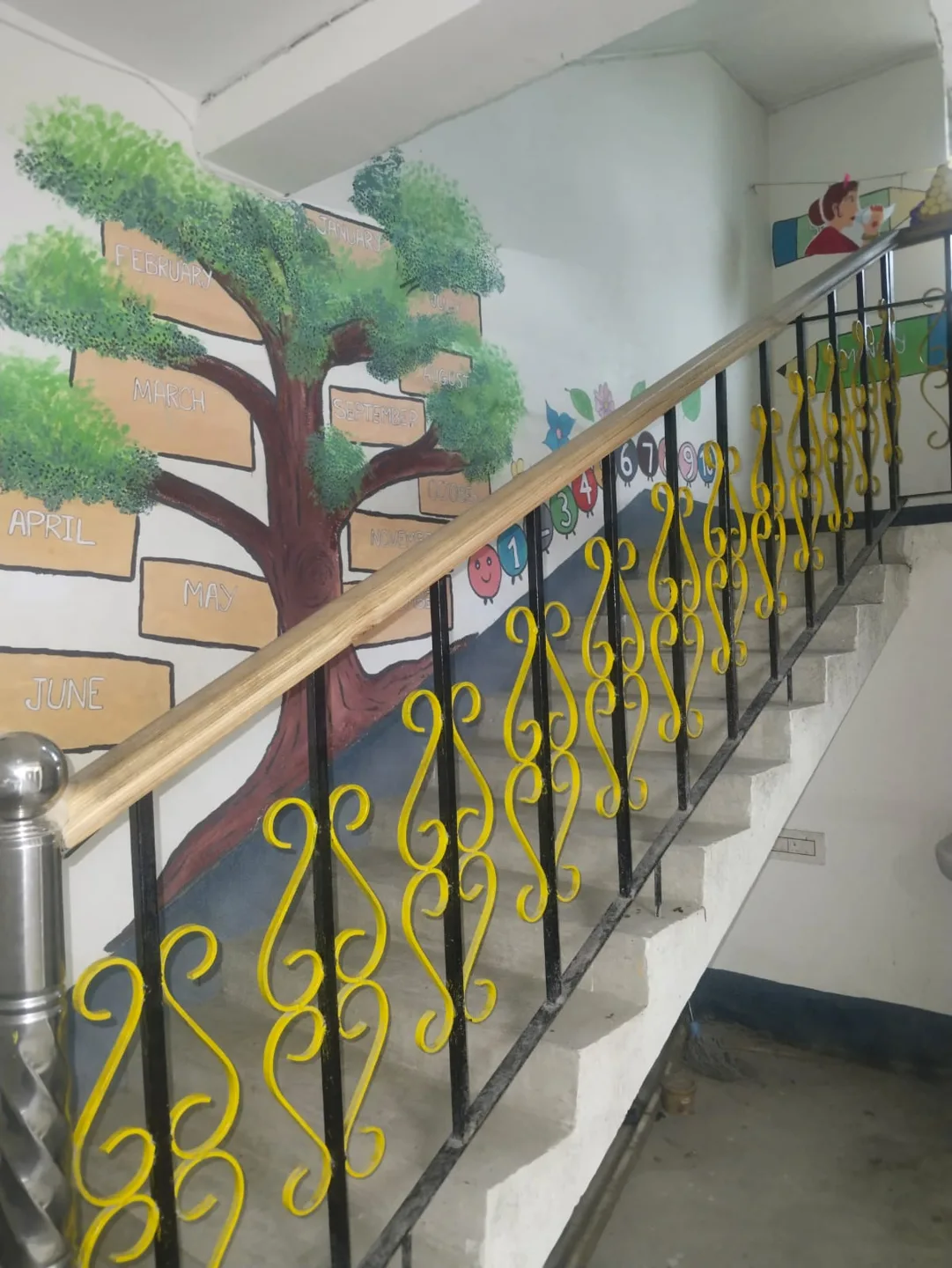 A tree and book mural beside the stairs
